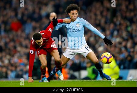 Liverpool's Trent Alexander-Arnold (left) and Manchester City's Leroy Sane battle for the ball during the Premier League match at the Etihad Stadium, Manchester. Stock Photo