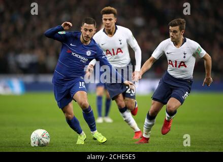 Chelsea's Eden Hazard (left) and Tottenham Hotspur's Harry Winks in actioni during the Carabao Cup, semi final match at Wembley, London. Stock Photo