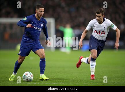 Chelsea's Eden Hazard (left) and Tottenham Hotspur's Harry Winks during the Carabao Cup, semi final match at Wembley, London. Stock Photo