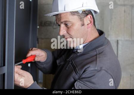 man assembles profile metal frame Stock Photo