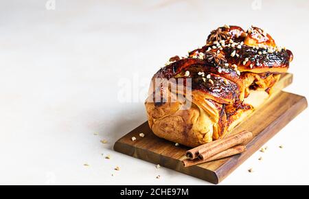 Swirl brioche with apricot jam, nuts, cinnamon and anise star. Braided or roll bread, Babka. Stock Photo