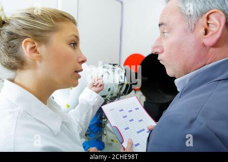 afemale jet engineer talking to boss Stock Photo