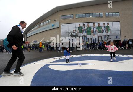 Fans play football outside the ground before the FA Cup fourth round match at the AMEX Stadium, Brighton. Stock Photo