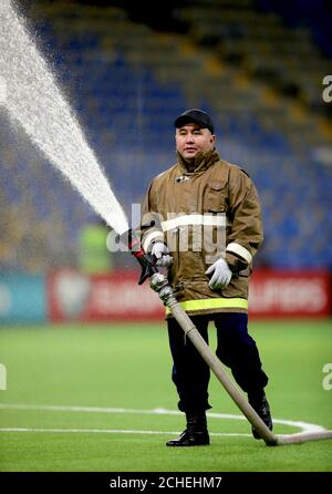 A fireman waters the pitch ahead of the UEFA Euro 2020 Qualifying, Group I match at the Astana Arena. Stock Photo