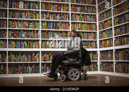 Yinka Shonibare with his work, The British Library, at Tate Modern, London, the latest artwork to be acquired by Tate. Stock Photo