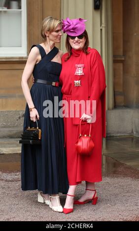 Fashion designer Gabriel Hearst (left) stands with fashion magazine editor Glenda Bailey who was made a Dame Commander of the British Empire for services to UK prosperity, charity, fashion and journalism by the Prince of Wales, following an investiture ceremony at Buckingham Palace, London. Stock Photo