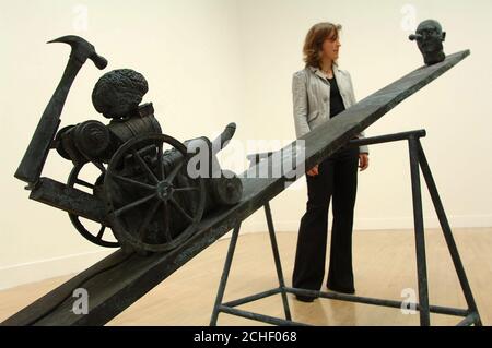 NOTE GRAPHIC CONTENT.  Press officer Louise Butler looks at a section from 'When Humans Walked the Earth'; a new work by British artists Jake and Dinos Chapman, on display at the Tate Britain gallery, London. Stock Photo