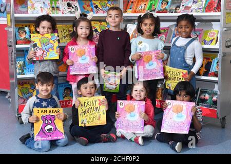 EDITORIAL USE ONLY School children hold books at Rosebank Primary School in Leeds at a pop-up book fair, highlighting books by authors and illustrators of colour or those that feature BAME main characters, which has been organised by BookTrust and Scholastics following research that found that less than 2% of published authors and illustrators in the UK are British people of colour Stock Photo