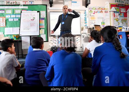 EDITORIAL USE ONLY School children at Rosebank Primary School in Leeds meet author Bali Rai at a pop-up book fair, highlighting books by authors and illustrators of colour or those that feature BAME main characters, which has been organised by BookTrust and Scholastics following research that found that less than 2% of published authors and illustrators in the UK are British people of colour. Stock Photo