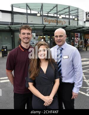 EDITORIAL USE ONLY Actress Rachel Shenton, who is an ambassador for the National Deaf Children's Society, Sainsbury???s colleague Sam Book, who is deaf, and Paul Robertson, general manager, unveils the new store front, as Sainsbury???s in Bath has transformed into Signsbury???s for the weekend. Stock Photo
