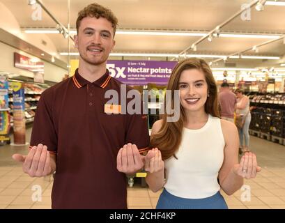 EDITORIAL USE ONLY Actress Rachel Shenton, who is an ambassador for the National Deaf Children's Society, demonstrates sign language with Sainsbury???s colleague Sam Book, who is deaf, as the supermarket???s store in Bath has transformed into Signsbury???s for the weekend. Stock Photo