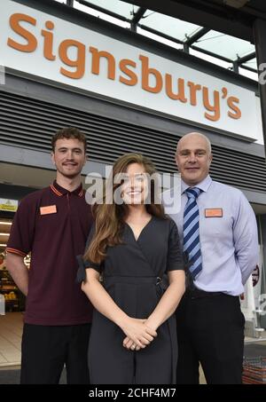 EDITORIAL USE ONLY Actress Rachel Shenton, who is an ambassador for the National Deaf Children's Society, Sainsbury???s colleague Sam Book, who is deaf, and Paul Robertson, general manager, unveils the new store front, as Sainsbury???s in Bath has transformed into Signsbury???s for the weekend.  Stock Photo