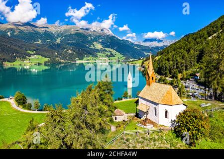 St. Anna Chapel and Submerged Bell Tower of Curon on Lake Reschen in South Tyrol, Italy Stock Photo