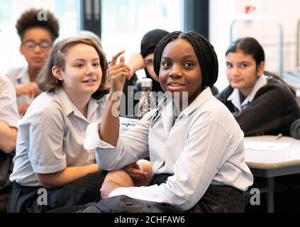 EDITORIAL USE ONLY Students and teachers from the Archer Academy in East Finchley participate in an educational session led by the National Citizen Service (NCS), which has been designed to encourage and support youth social activism outside the classroom, London. Stock Photo