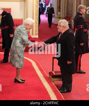 Sir Simon Russell Beale is made a Knight Bachelor of the British Empire by Queen Elizabeth II at Buckingham Palace.