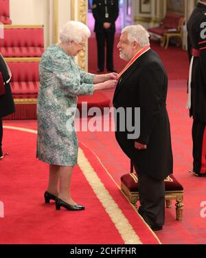 Sir Simon Russell Beale is made a Knight Bachelor of the British Empire by Queen Elizabeth II at Buckingham Palace.