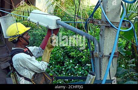 Electricians repairing a street lighting on pole Stock Photo