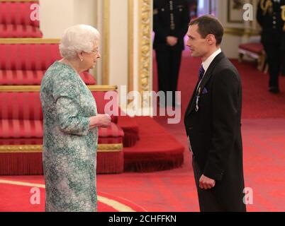 Mr. Christopher Jewell is decorated with the Queen's Gallantry Medal by Queen Elizabeth II at Buckingham Palace. Stock Photo