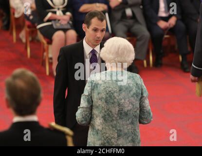 Mr. Christopher Jewell is decorated with the Queen's Gallantry Medal by Queen Elizabeth II at Buckingham Palace. Stock Photo