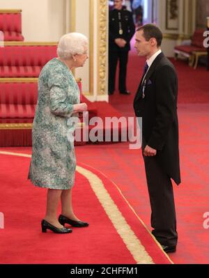 Mr. Christopher Jewell is decorated with the Queen's Gallantry Medal by Queen Elizabeth II at Buckingham Palace. Stock Photo