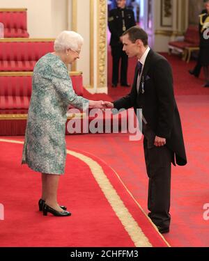 Mr. Christopher Jewell is decorated with the Queen's Gallantry Medal by Queen Elizabeth II at Buckingham Palace. Stock Photo