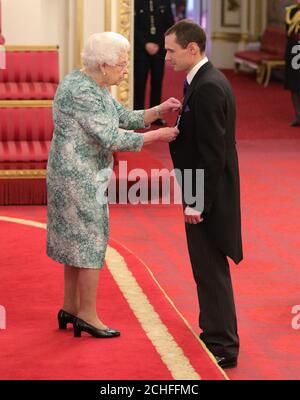 Mr. Christopher Jewell is decorated with the Queen's Gallantry Medal by Queen Elizabeth II at Buckingham Palace. Stock Photo