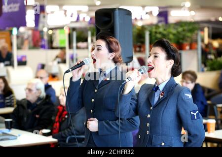 EDITORIAL USE ONLY The D-Day Darlings perform at a tea party hosted by Sainsbury's for the Armed Forces community in Chichester, to raise funds for this year's Poppy Appeal. PA Photo. Picture date: Friday November 8, 2019. Burnand received a commemorative bouquet dedicated to his late father, who served in the First World War at the tea party hosted by his supermarket colleagues. This year, Sainsbury's celebrates its 25th year of partnering with The Royal British LegionÕs Poppy Appeal. Photo credit should read: Matt Alexander/PA Wire  Stock Photo