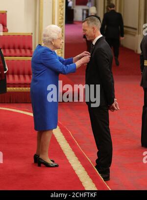 Detective Superintendent Mark Gower from Reading is made an OBE (Officer of the Order of the British Empire) by Queen Elizabeth II, during an investiture ceremony at Buckingham Palace in London. Stock Photo