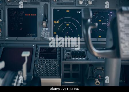 Aircraft flight deck with switches and flight displays Stock Photo
