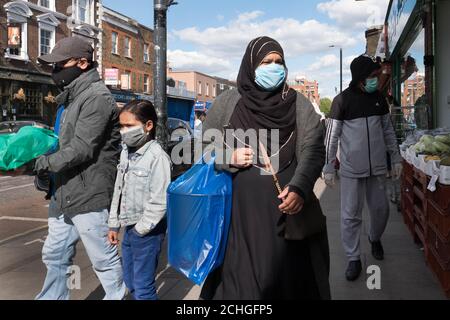 Members of the Islamic community in Bethnal Green, east London go about their daily business during the holy month of Ramadan as the UK continues in lockdown to help curb the spread of the coronavirus. Stock Photo