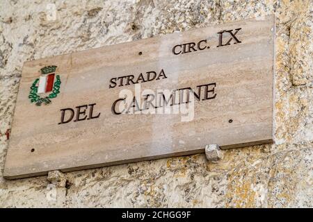 BARI, ITALY - SEPTEMBER 1, 2020: sunlight is enlightening signboard of Carmine Street Stock Photo