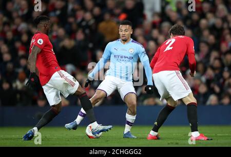 Manchester City's Gabriel Jesus trys to get past Manchester United's Aaron Wan-Bissaka and Manchester United's Victor Lindelof (right) during the Premier League match at Old Trafford, Manchester Stock Photo