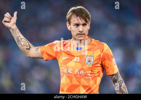 Brazilian football player Roger Krug Guedes, known as Roger Guedes, of Shandong Luneng Taishan F.C. reacts during the eleventh-round match of 2020 Chinese Super League (CSL) against Guangzhou Evergrande Taobao F.C., Dalian city, northeast China's Liaoning province, 13 September 2020. Shandong Luneng Taishan F.C. was defeated by Guangzhou Evergrande Taobao F.C. with 1-2. Stock Photo