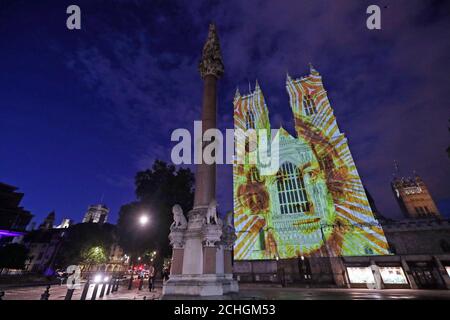 An image of Charles Dickens is projected onto the West Towers of Westminster Abbey in London to mark the 150th anniversary (Tuesday) of the death of one of the nation's greatest authors. The Dean of Westminster, the Very Reverend Dr David Hoyle, will lay a wreath and say prayers at the writer's grave in the Abbey's South Transept. Stock Photo