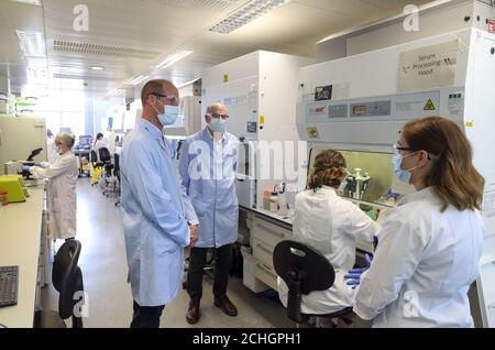 The Duke of Cambridge wears a mask as he meets scientists, including Christina Dold (right), during a visit to the manufacturing laboratory where a vaccine against COVID-19 has been produced at the Oxford Vaccine Group's facility at the Churchill Hospital in Oxford. Stock Photo