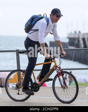 Tobias Ellwood, Conservative MP for Bournemouth East, cycles away from Bournemouth beach after giving interviews to TV, as thunderstorms and torrential rain are forecast to sweep across the UK, bringing an end to a week of blazing sunshine and scorching temperatures. PA Photo. Picture date: Friday June 26, 2020. The change in weather comes as the UK experienced its hottest day of the year so far on Thursday, with the mercury rising to 33.4C (92.1F) at Heathrow Airport in west London. See PA story WEATHER Storm. Photo credit should read: Andrew Matthews/PA Wire Stock Photo