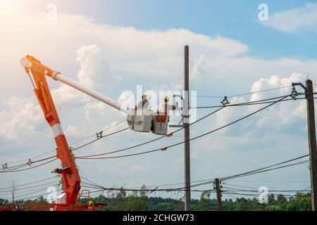 The electrician teamwork installation of high voltage   on the cable car Stock Photo