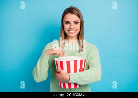 Close-up portrait of her she nice-looking attractive lovely pretty charming cute cheerful cheery girl holding in hands eating corn isolated over Stock Photo