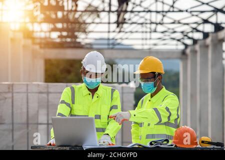engineering and construction  in the construction site masked because effector coronavirus Stock Photo