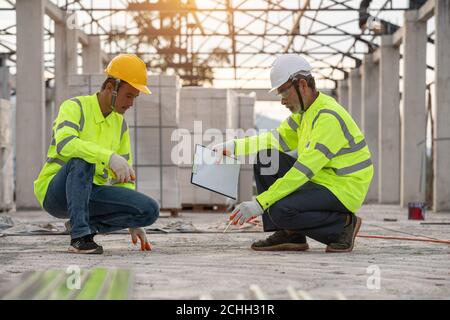 Quality inspection of cement floors by supervisor engineers and workers Stock Photo