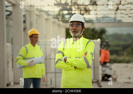 Supervisor and engineering in the construction site and blueprint Stock Photo