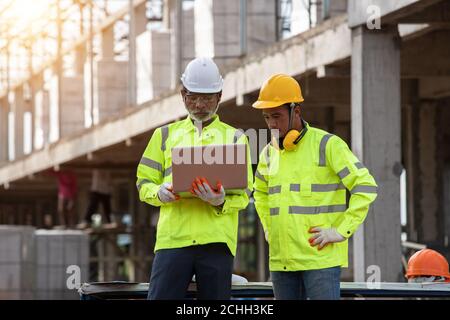 Supervisors and engineering use laptop at the construction site Stock Photo