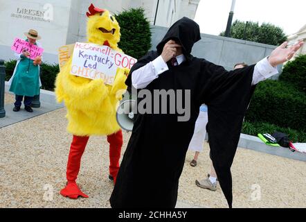 Anti-abortion protesters, including one dressed as Death and one dressed to decry Republicans as 'chickens,' stand outside a U.S. Senate office building before Supreme Court nominee Elena Kagan arrives for the start of her U.S. Senate confirmation hearings in front of the Senate Judiciary Committee on Capitol Hill in Washington June 28, 2010.     REUTERS/Jonathan Ernst (UNITED STATES - Tags: POLITICS CRIME LAW CIVIL UNREST)