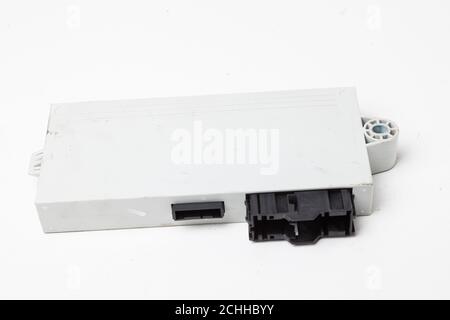 Plastic control unit of a car engine with black elements on a white isolated background - the connecting center of various subsystems, components and Stock Photo