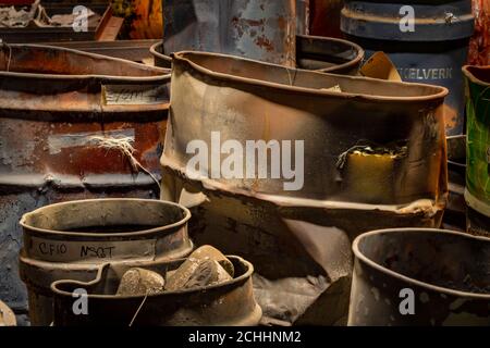 Dented and abused metal barrels in industrial refinery, Pennsylvania, USA Stock Photo