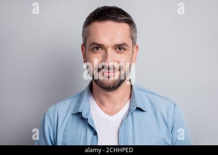 Close-up portrait of his he nice attractive content cheery mature guy private company worker wearing blue shirt isolated over gray light pastel color Stock Photo