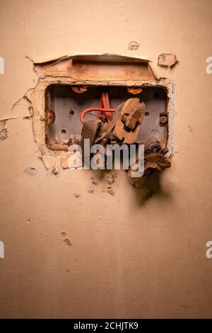 Vintage rusty broken double light switch panel from urbex exploration. Stock Photo