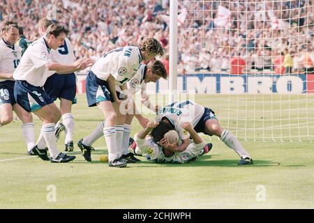 England teammates swamp Paul Gascoigne after scoring the second goal in the Euro 96 clash against Scotland at Wembley. Stock Photo