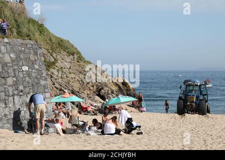 Tenby, Pembrokeshire, West Wales, UK. 14 September 2020.  UK weather:  People enjoy a walk along the coast today, with warm weather forecast for most of the week.  Credit: Andrew Bartlett/Alamy Live News. Stock Photo