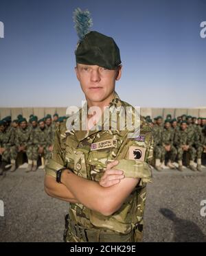 Lieutenant Pete Quentin, 27, serving with the London Regiment, a liaison officer working between the United States Marine Corps, the British Army and the Afghan National Army (ANA) during their training process stands in front of ANA soldiers prior to their graduation ceremony at Camp Leatherneck, next to the British base, Camp Bastion in Helmand Province, Afghanistan. PRESS ASSOCIATION Photo. Issue date: Thursday June 17, 2010. Camp Leatherneck is the base for 1 Marine Expeditionary Force, United States Marine Corps who lead the training of ANA soldiers. Photo credit should read: Sergeant Ian Stock Photo